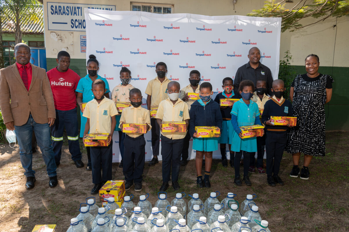 School children receiving water and school shoes from Huletts. 